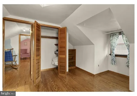 a view of empty room with wooden floor and cabinet