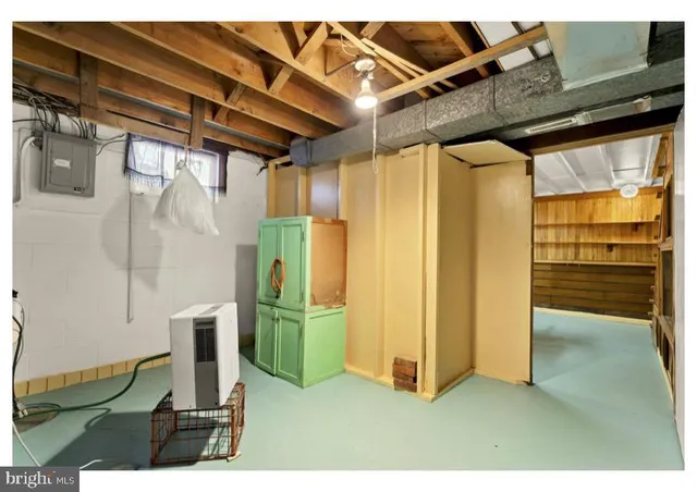 a view of a hallway with a white cabinet and a refrigerator