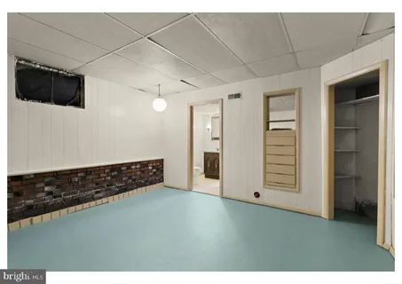 a view of an empty room with a kitchen