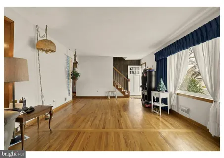 a view of empty room with furniture and window