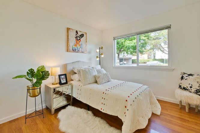 1127 Reed Avenue, Unit B Sunnyvale, CA 94086 - Photo 36 of 58 a bedroom with a bed and wooden floor