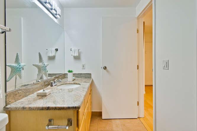 1127 Reed Avenue, Unit B Sunnyvale, CA 94086 - Photo 43 of 58 a en suite bathroom with a granite countertop sink and a mirror