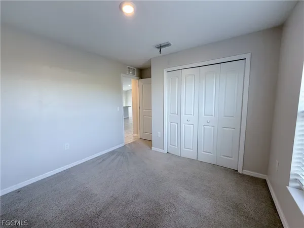 a bathroom with a granite countertop sink a toilet and a mirror