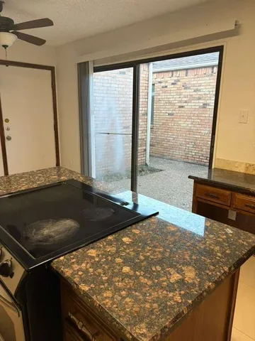 a kitchen with stainless steel appliances granite countertop a sink and a stove