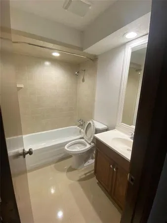 a bathroom with a sink a toilet and tub