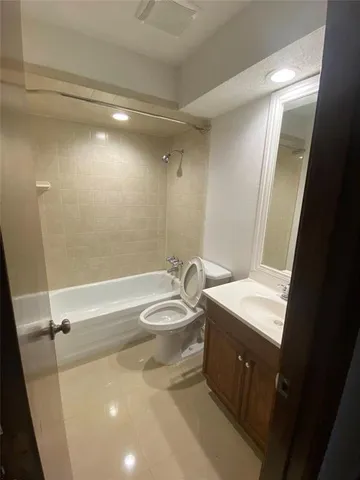 a bathroom with a sink a toilet and tub