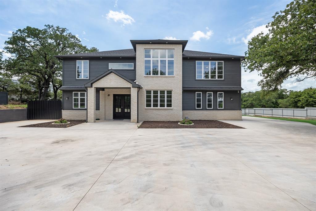 View of front of property featuring brick siding and driveway
