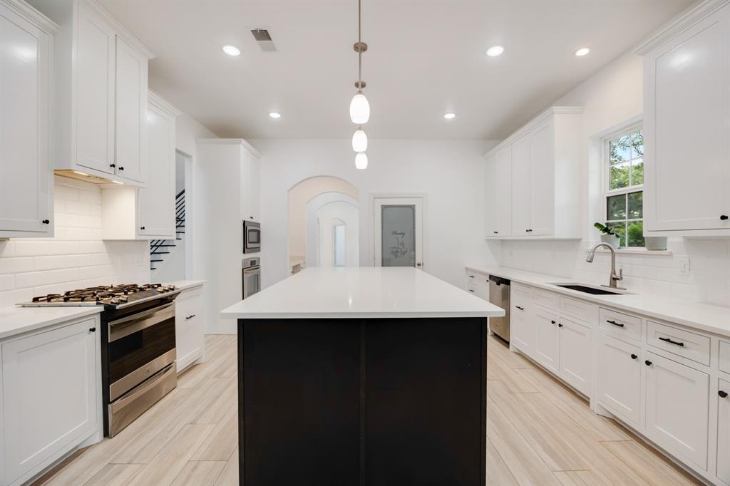 1016 Silver Creek Azle Road Azle, TX 76020 - Photo 12 of 40 Kitchen with appliances with stainless steel finishes, tasteful backsplash, white cabinets, and recessed lighting