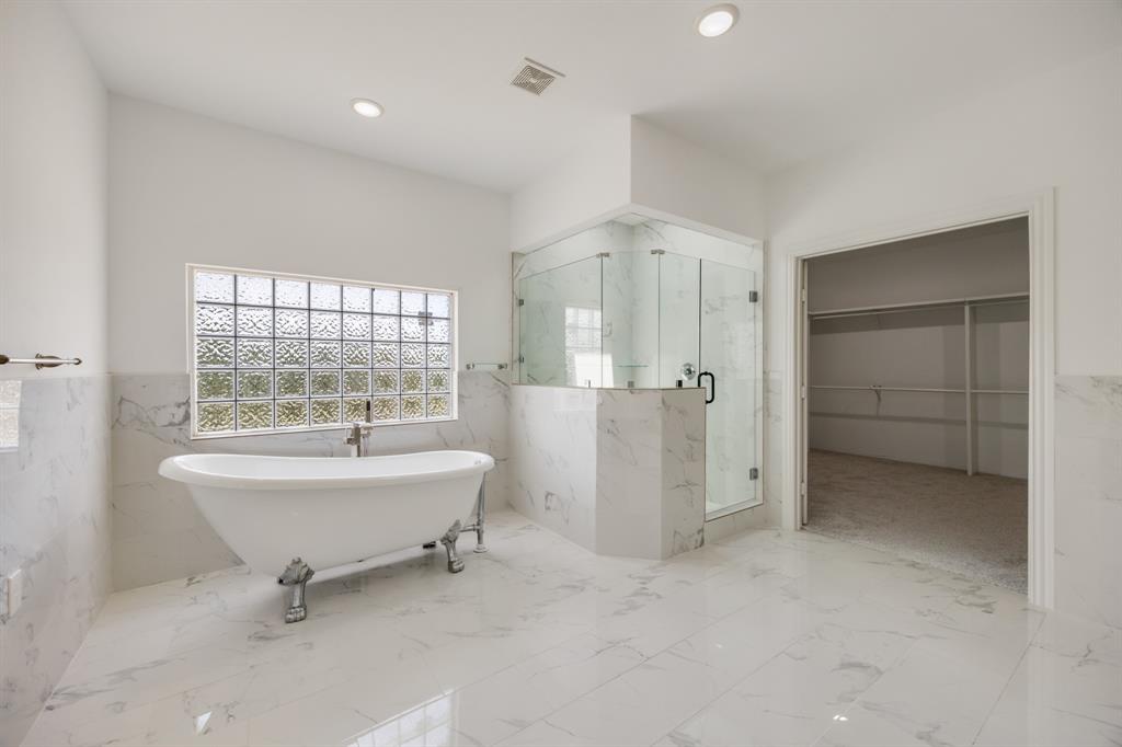 1016 Silver Creek Azle Road Azle, TX 76020 - Photo 17 of 40 Bathroom with a marble finish shower, a freestanding tub, a walk in closet, tile walls, and marble tiled flooring