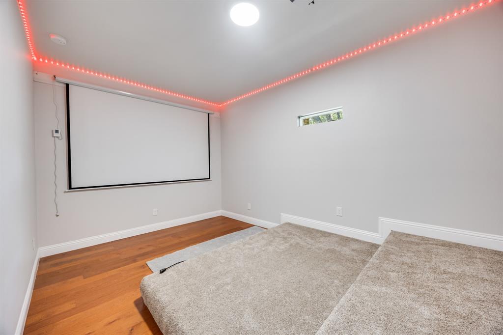 1016 Silver Creek Azle Road Azle, TX 76020 - Photo 22 of 40 Home theater room with wood finished floors and baseboards