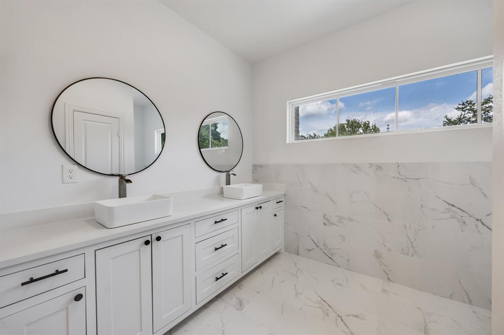 1016 Silver Creek Azle Road Azle, TX 76020 - Photo 24 of 40 Full bath with marble finish flooring, double vanity, healthy amount of natural light, and tile walls