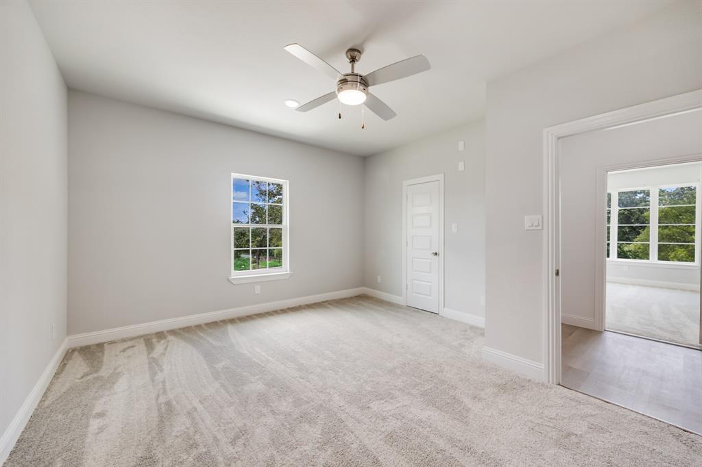 1016 Silver Creek Azle Road Azle, TX 76020 - Photo 25 of 40 Carpeted spare room with a ceiling fan and baseboards