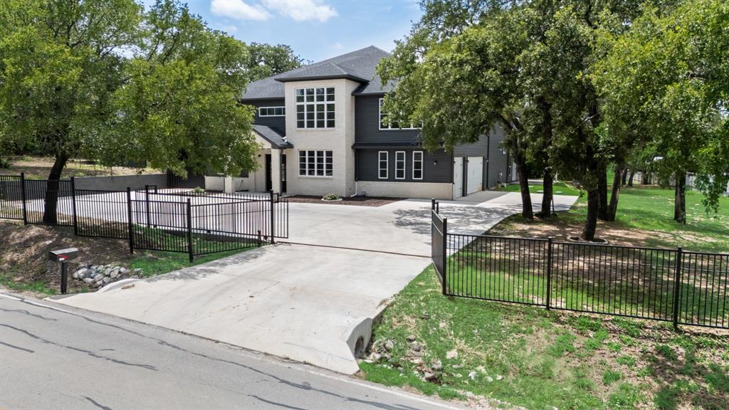 1016 Silver Creek Azle Road Azle, TX 76020 - Photo 3 of 40 Traditional-style house featuring concrete driveway, a fenced front yard, and a shingled roof