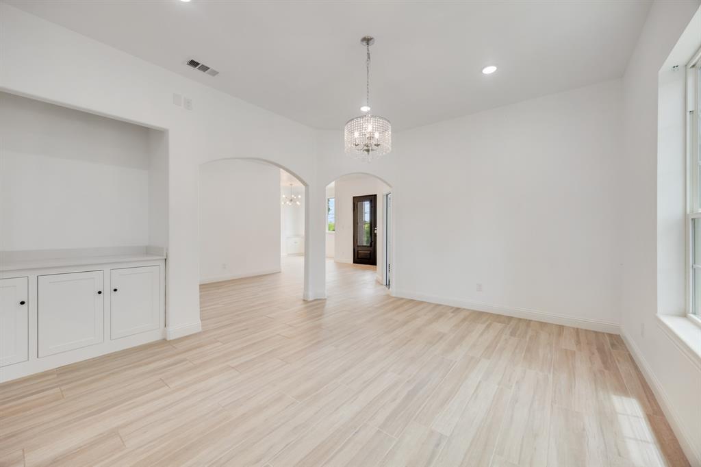 1016 Silver Creek Azle Road Azle, TX 76020 - Photo 32 of 40 Spare room with arched walkways, a chandelier, light wood-type flooring, and recessed lighting