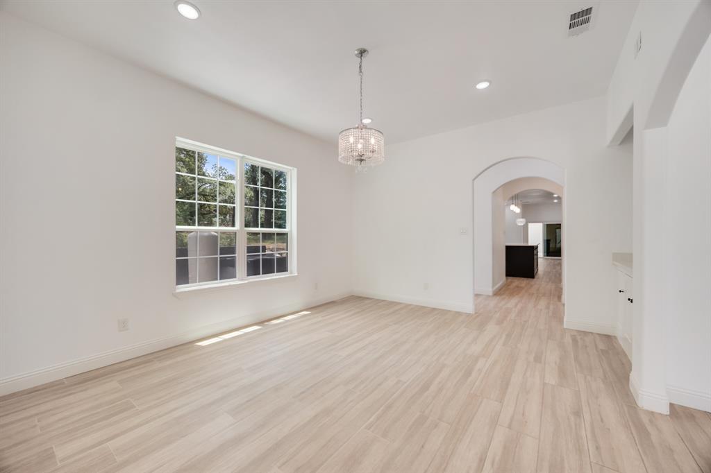 1016 Silver Creek Azle Road Azle, TX 76020 - Photo 33 of 40 Unfurnished room with arched walkways, a chandelier, recessed lighting, and light wood-type flooring