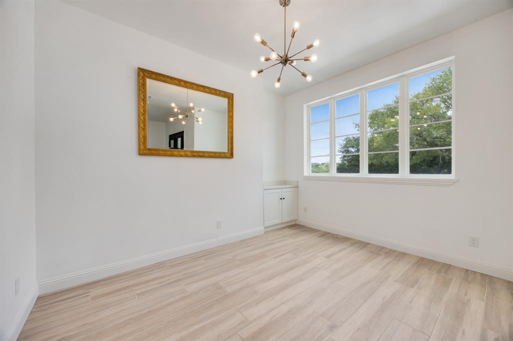 1016 Silver Creek Azle Road Azle, TX 76020 - Photo 35 of 40 Unfurnished room featuring a chandelier and wood finished floors