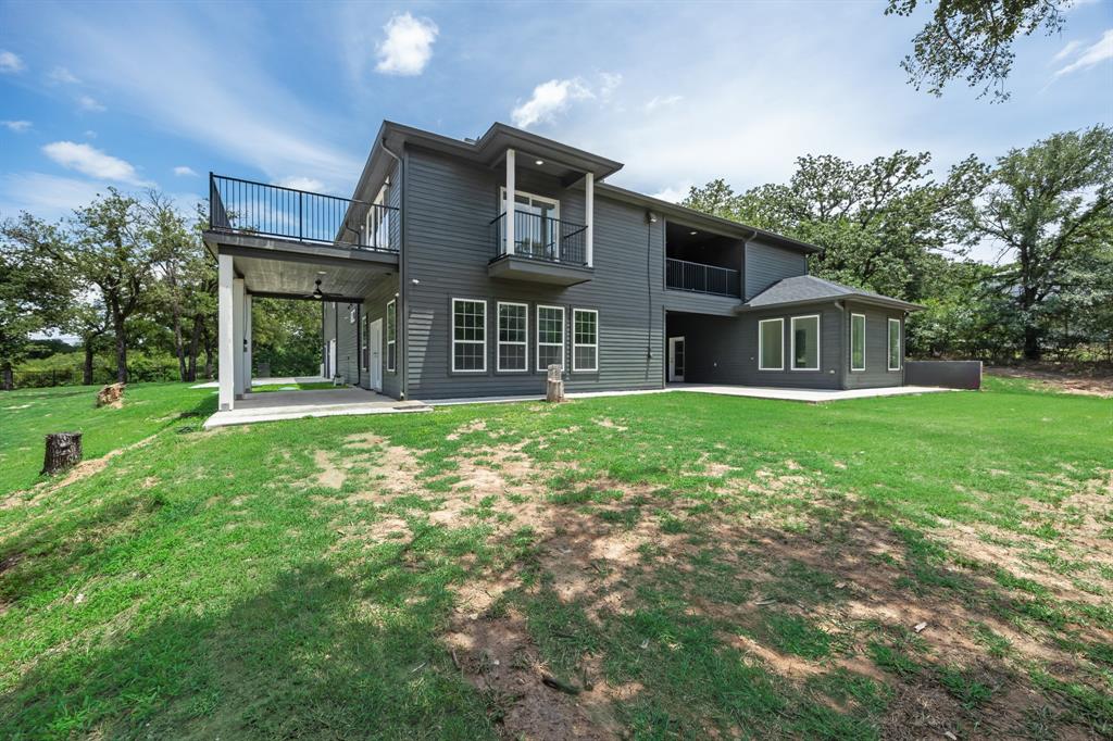 1016 Silver Creek Azle Road Azle, TX 76020 - Photo 37 of 40 Back of property with a balcony, a patio, and a lawn