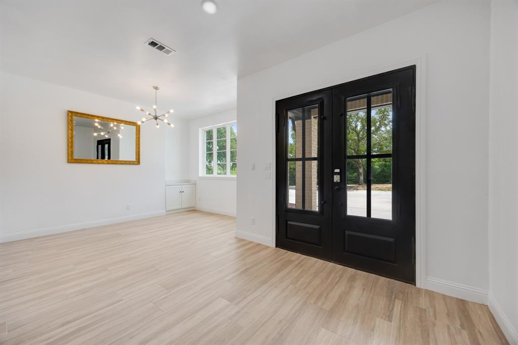 1016 Silver Creek Azle Road Azle, TX 76020 - Photo 5 of 40 Entrance foyer featuring french doors, a chandelier, and light wood-style flooring
