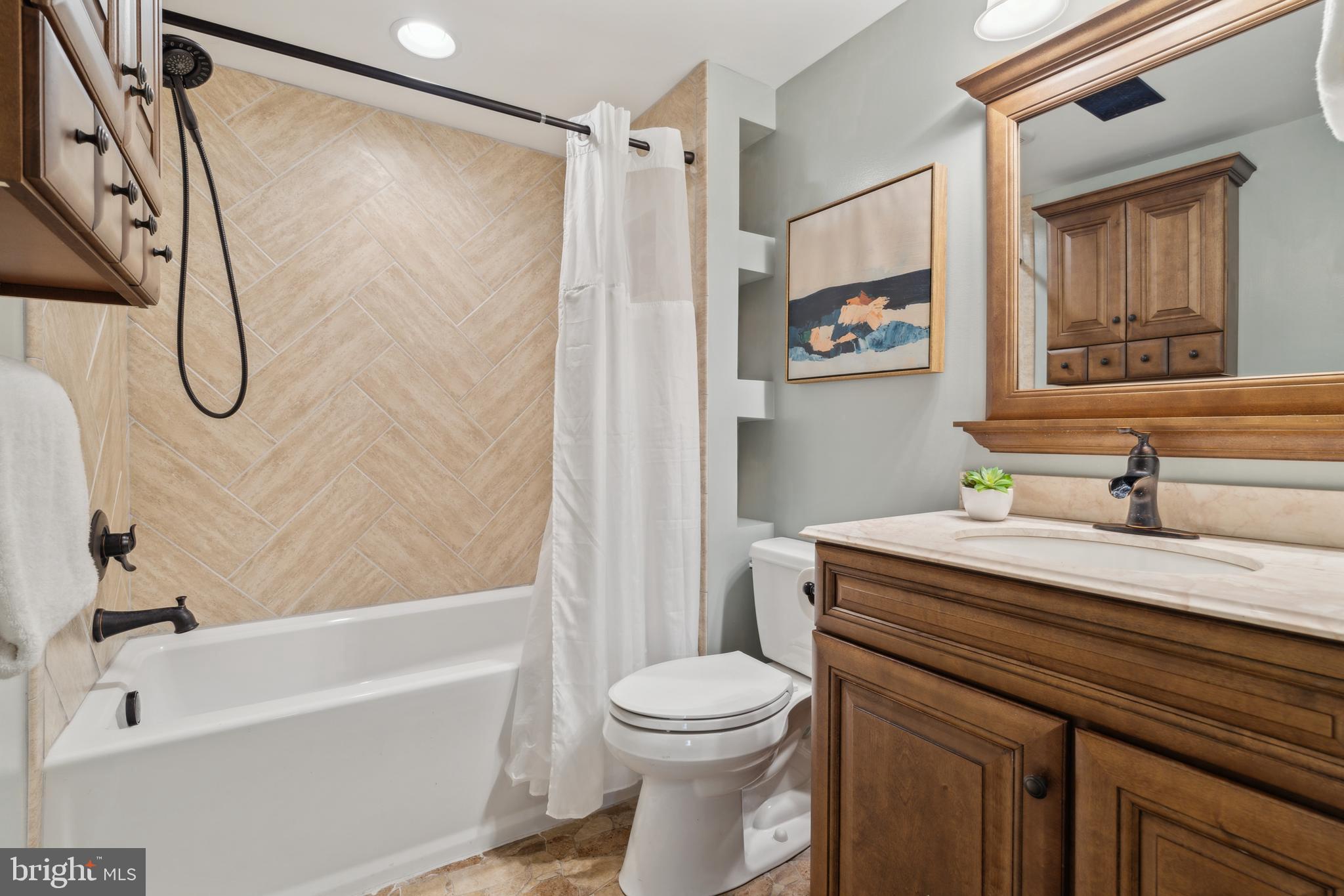 698 Benfield Road Severna Park, MD 21146 - Photo 23 of 28 a bathroom with a sink a toilet and a bathtub