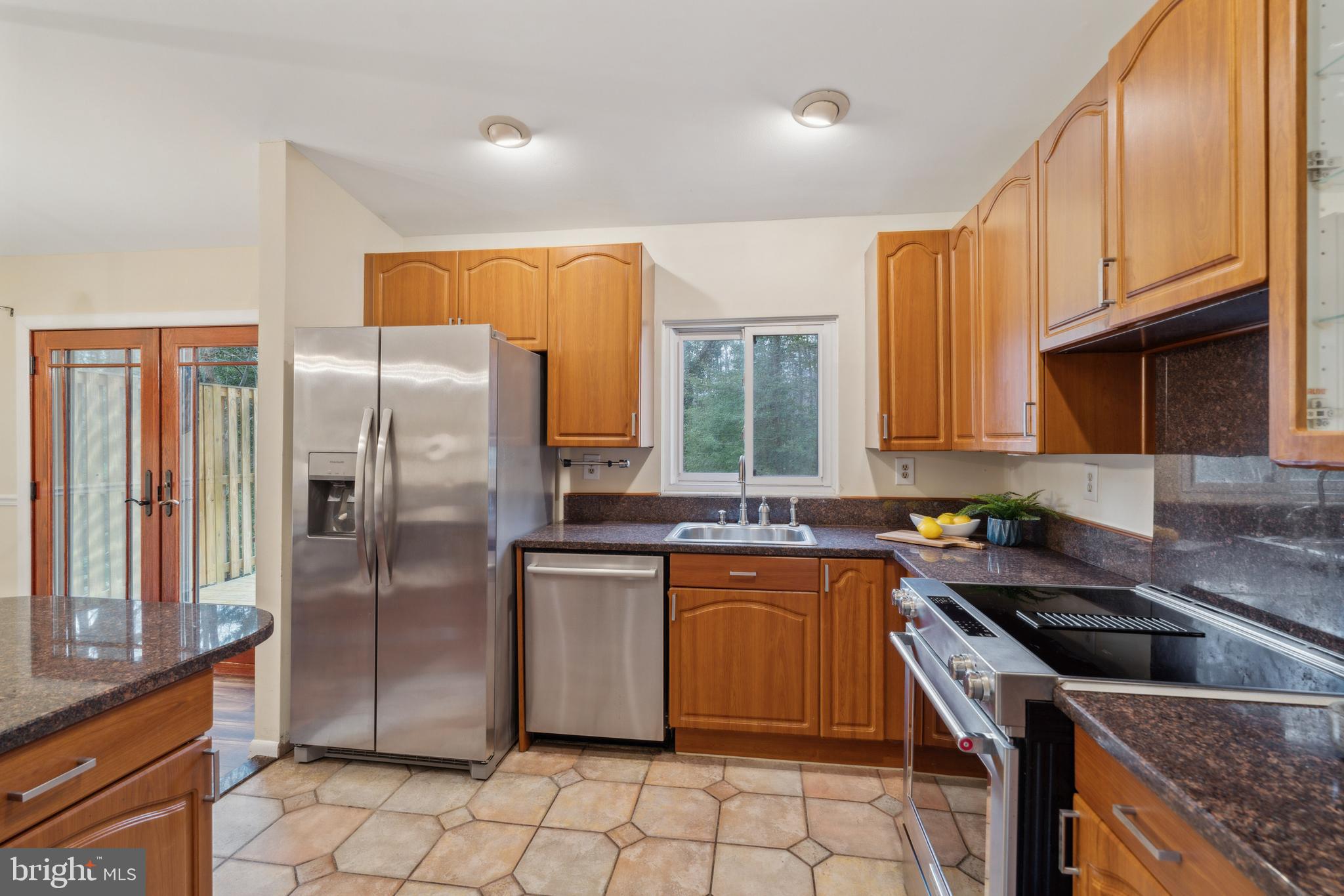 698 Benfield Road Severna Park, MD 21146 - Photo 8 of 28 a kitchen with stainless steel appliances granite countertop a sink stove refrigerator and cabinets