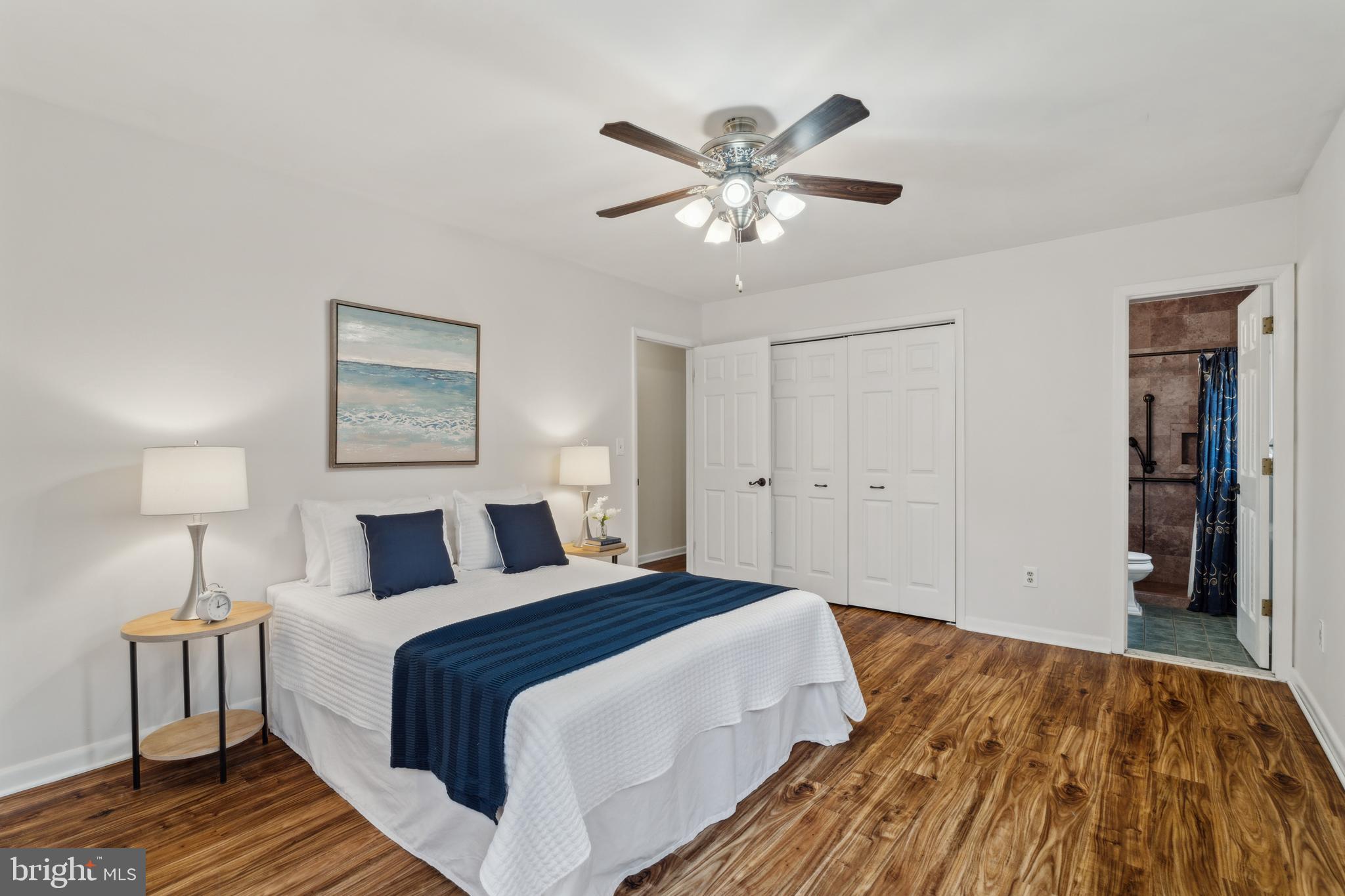 698 Benfield Road Severna Park, MD 21146 - Photo 10 of 28 a bedroom with a bed and a chandelier