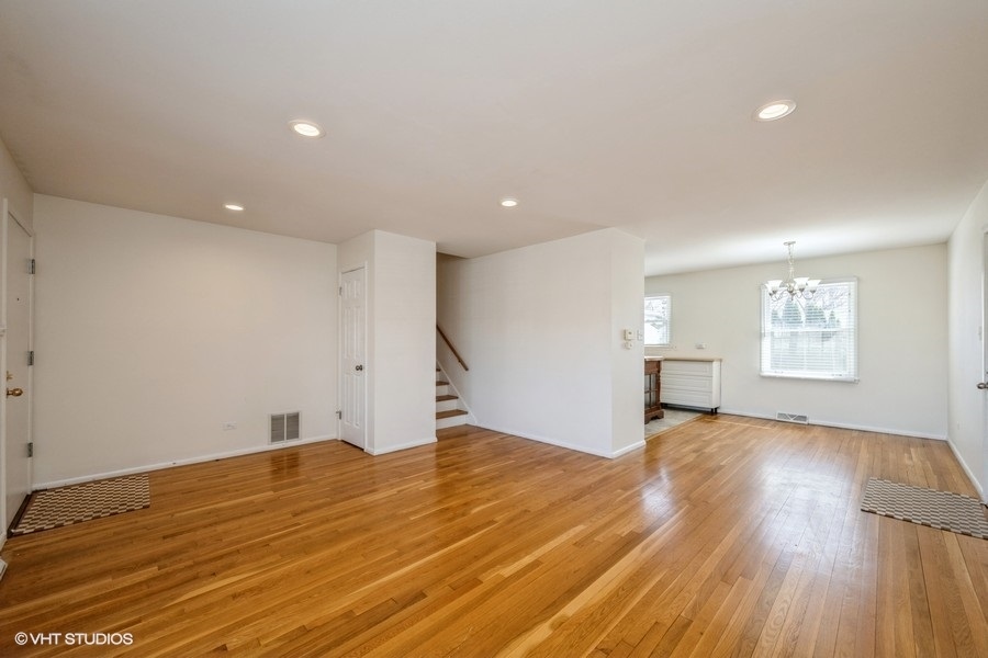 3208 Wren Lane Rolling Meadows, IL 60008 - Photo 2 of 18 a view of an empty room with wooden floor and a window