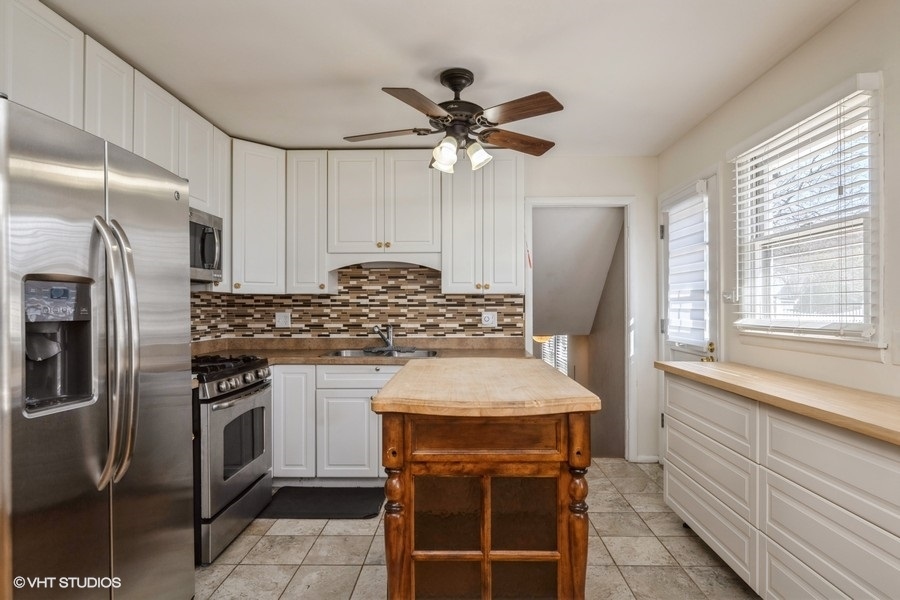 3208 Wren Lane Rolling Meadows, IL 60008 - Photo 4 of 18 a kitchen with stainless steel appliances granite countertop a sink a stove and a refrigerator