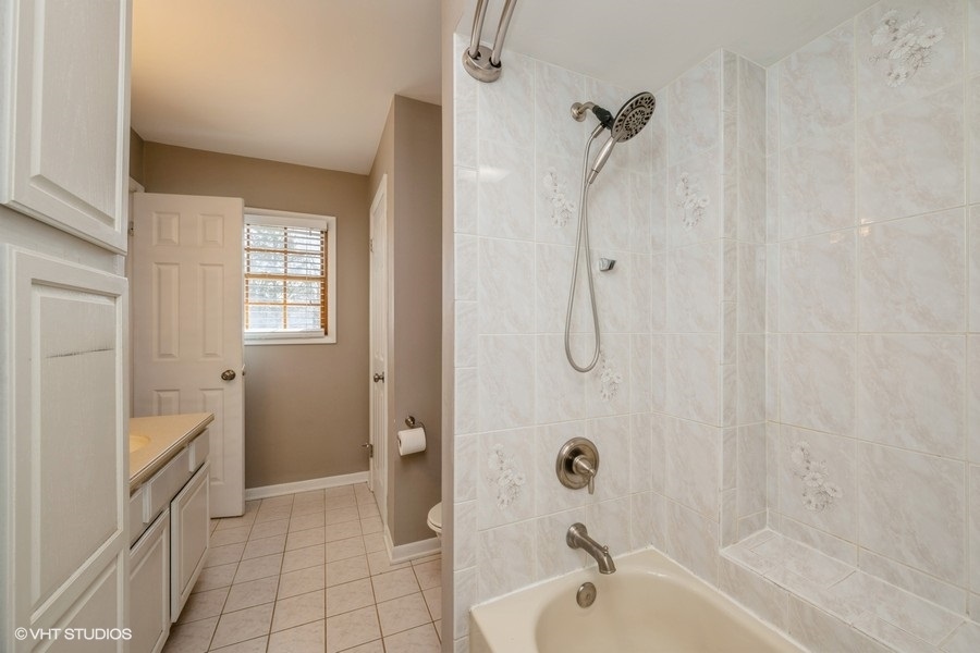 3208 Wren Lane Rolling Meadows, IL 60008 - Photo 8 of 18 a bathroom with a granite countertop sink a toilet and shower