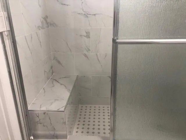 a bathroom with a glass shower door