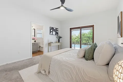 a bed sitting in a bedroom next to a window