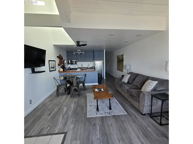 a large bed sitting in a bedroom next to a window