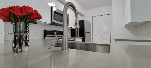 a view of a room with wooden floor and a window