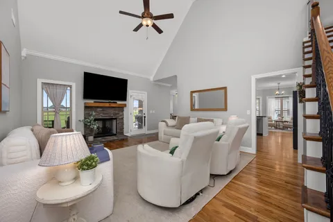 a living room with furniture a fireplace and a flat screen tv