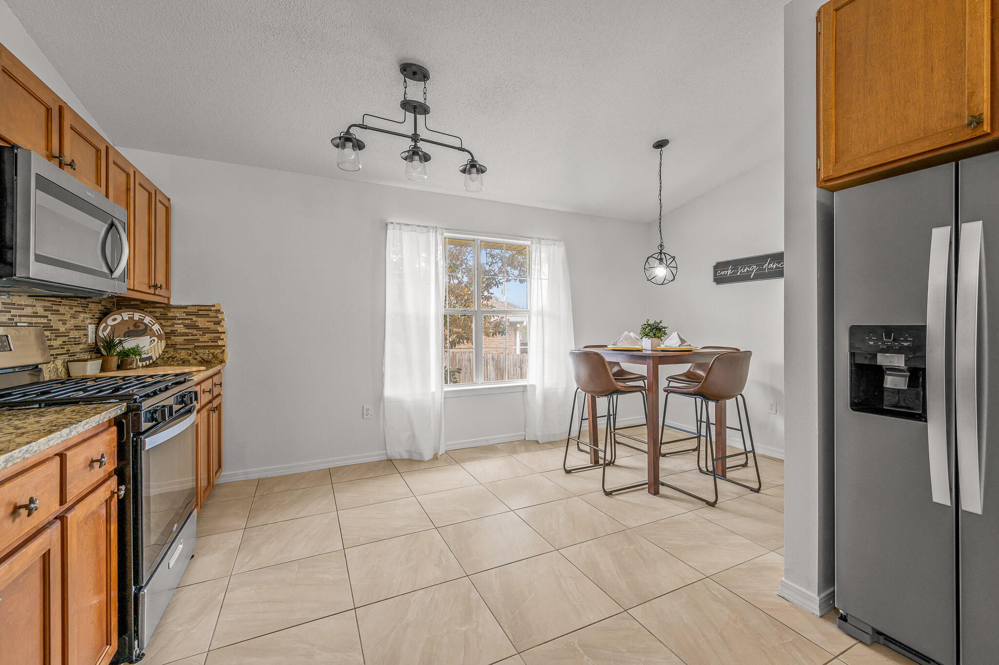 5186 Whitehurst Lane Crestview, FL 32536 - Photo 18 of 55 a kitchen with stainless steel appliances granite countertop a refrigerator and a stove top oven