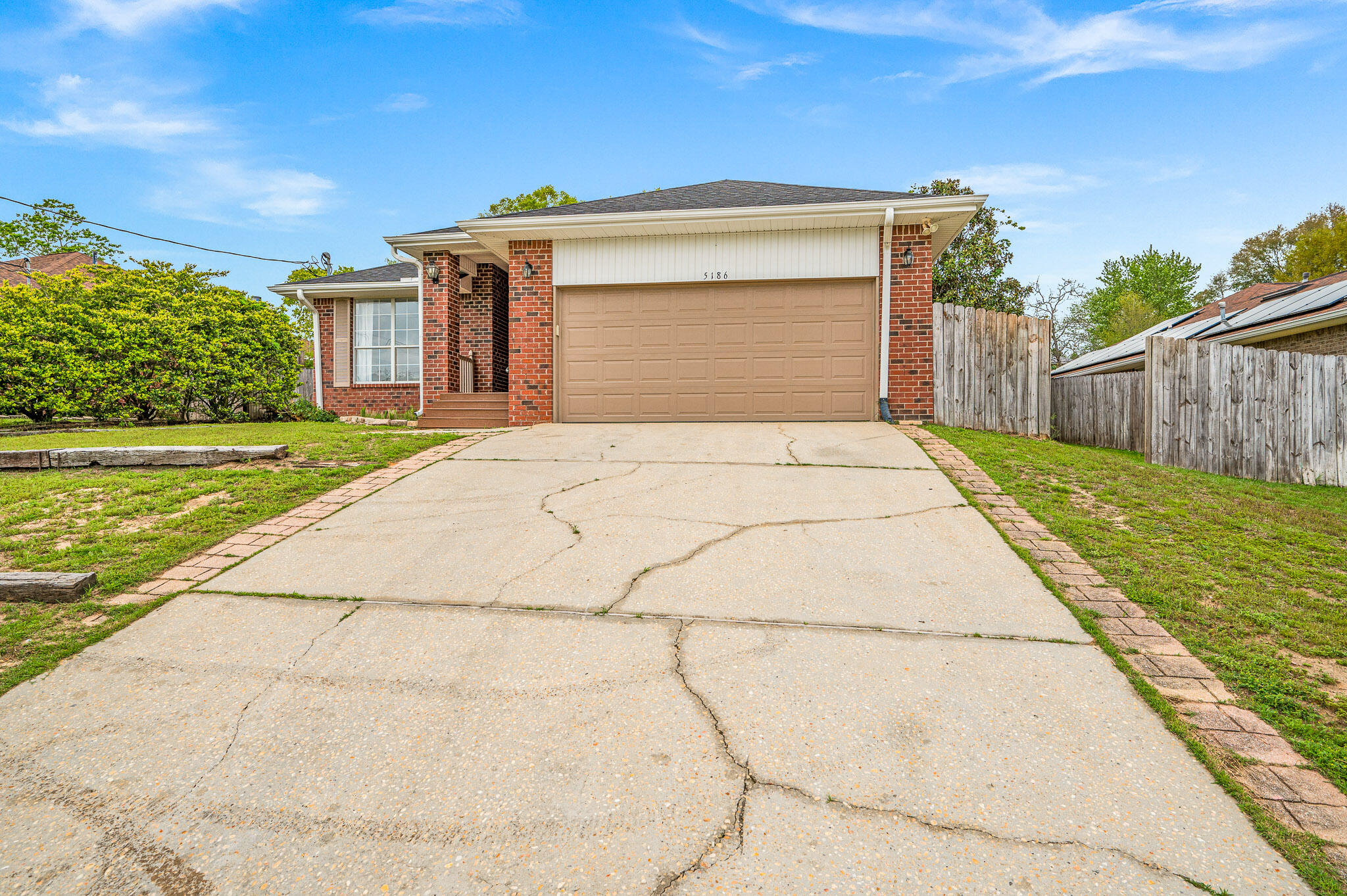5186 Whitehurst Lane Crestview, FL 32536 - Photo 2 of 55 a front view of a house with a yard and garage