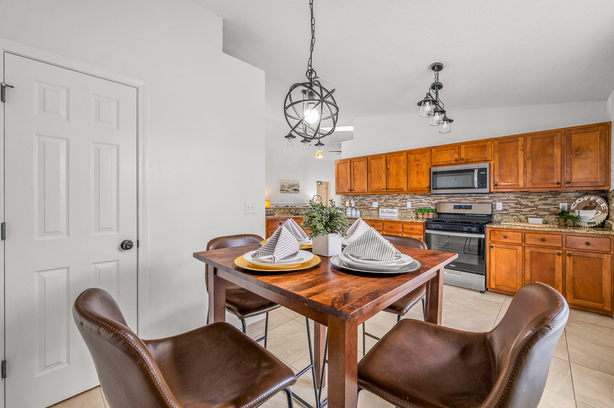 5186 Whitehurst Lane Crestview, FL 32536 - Photo 22 of 55 a view of a dining room with furniture a chandelier and wooden floor