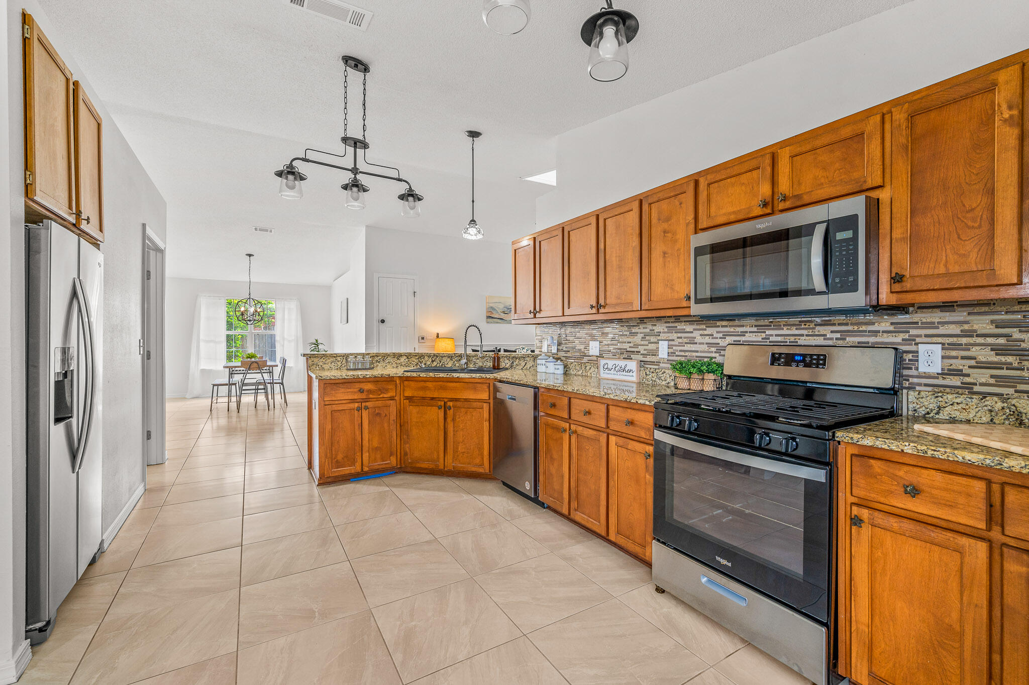 5186 Whitehurst Lane Crestview, FL 32536 - Photo 23 of 55 a kitchen with stainless steel appliances granite countertop a stove cabinets and a sink