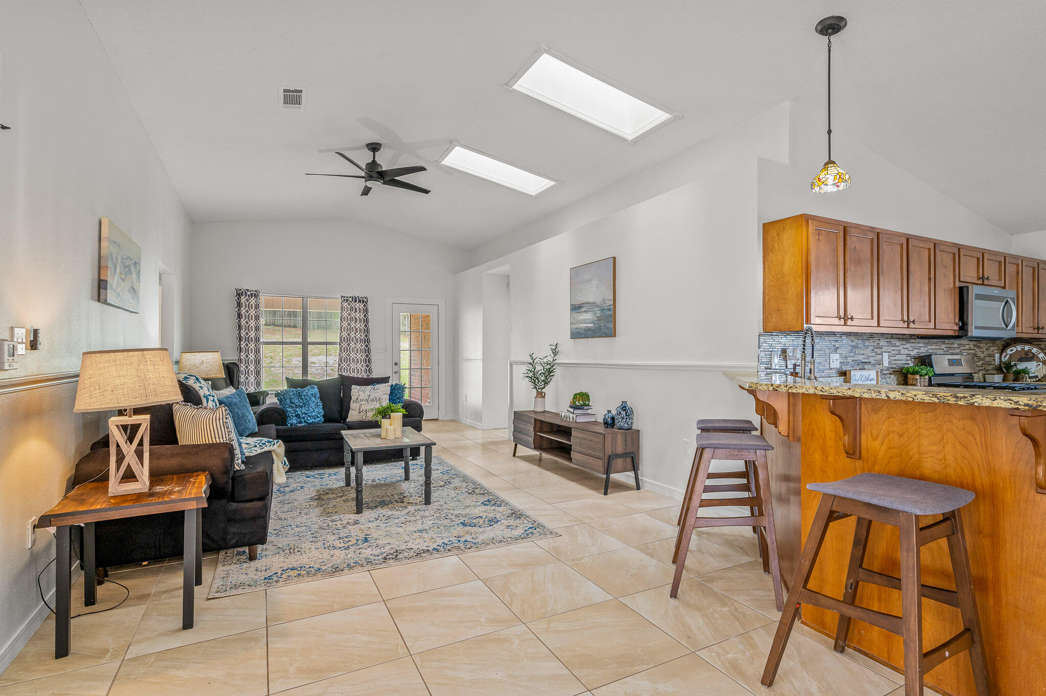 5186 Whitehurst Lane Crestview, FL 32536 - Photo 26 of 55 a living room with furniture a dining table and a chandelier