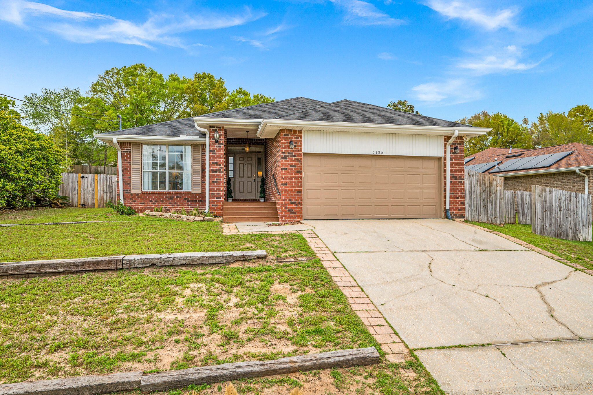 5186 Whitehurst Lane Crestview, FL 32536 - Photo 3 of 55 a front view of a house with a yard and potted plants