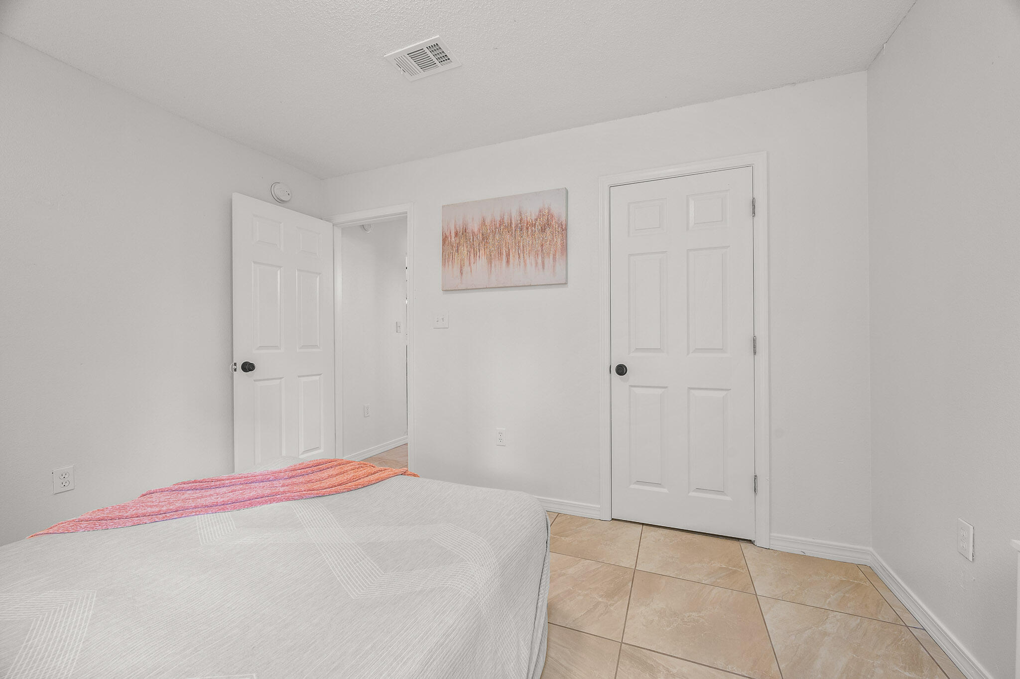 5186 Whitehurst Lane Crestview, FL 32536 - Photo 41 of 55 a bedroom with a bed and a painting on the wall