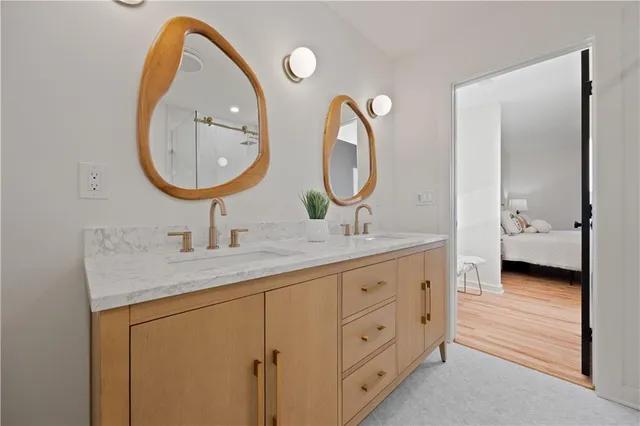 a en suite bathroom with a granite countertop toilet a sink and a mirror