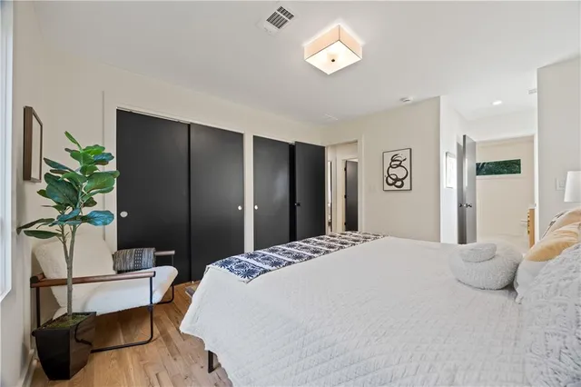 a bedroom with a bed and a potted plant