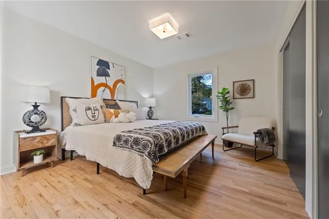 a bedroom with a bed and wooden floor