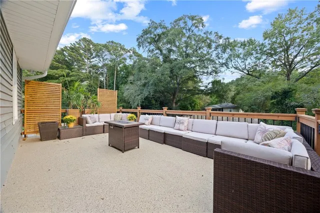 a view of roof deck with couches and potted plant