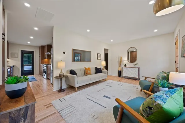 a living room with furniture and a potted plant