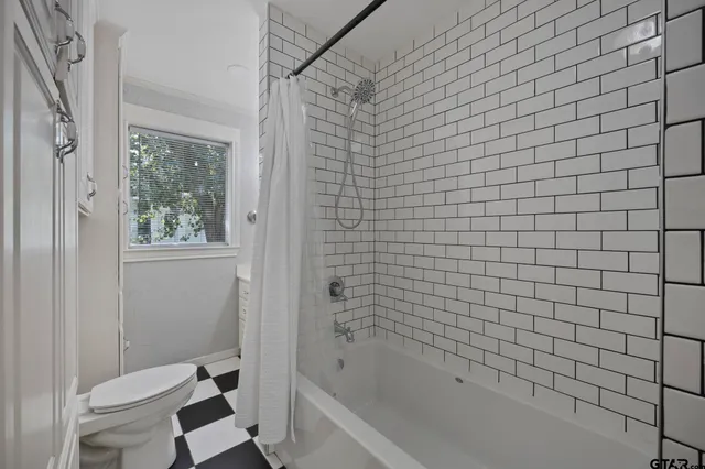 a bathroom with a bathtub and toilet