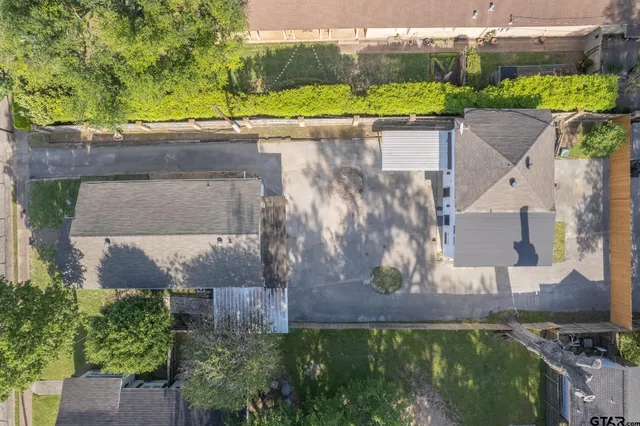 an aerial view of a house with a yard and a lake view