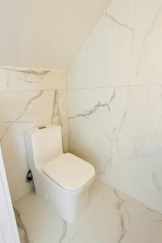 a white toilet sitting next to a white sink