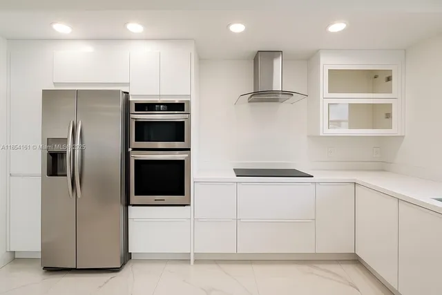 a kitchen with stainless steel appliances cabinets and a refrigerator