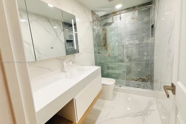 a bathroom with a bathtub shower sink and mirror
